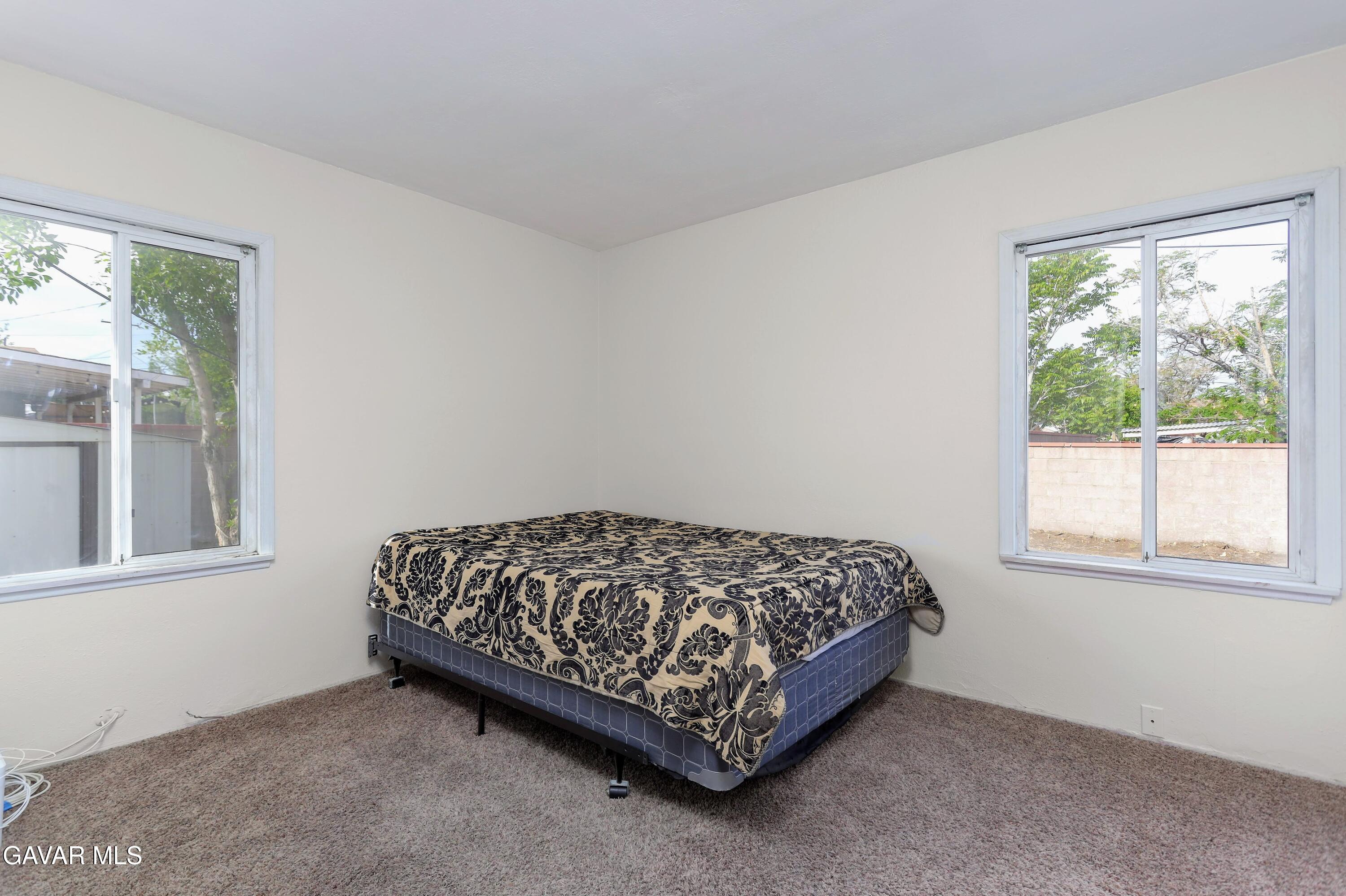 44265 Foxton Avenue Lancaster, CA 93535 - Photo 13 of 20 a bed sitting in a bedroom next to a window