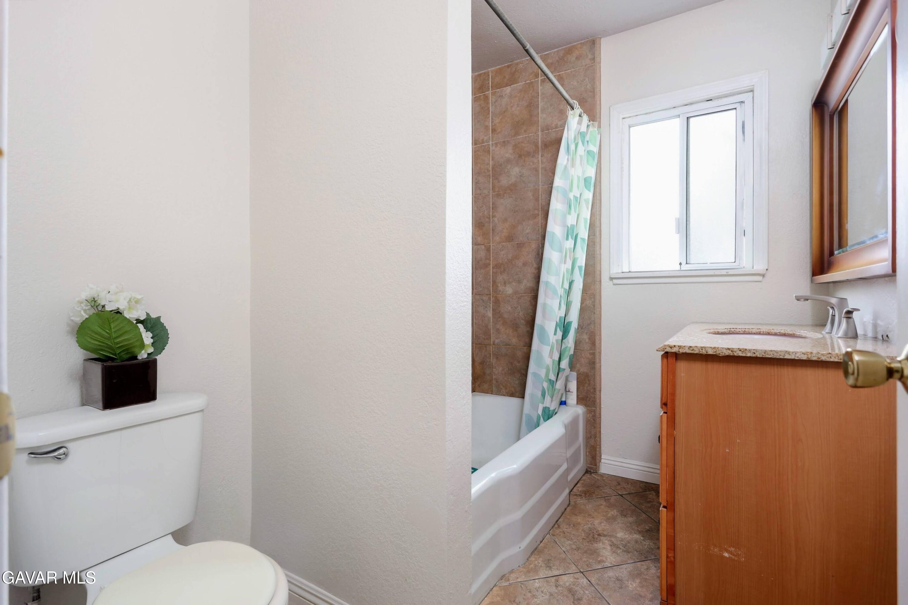 44265 Foxton Avenue Lancaster, CA 93535 - Photo 15 of 20 a bathroom with a granite countertop sink toilet and shower