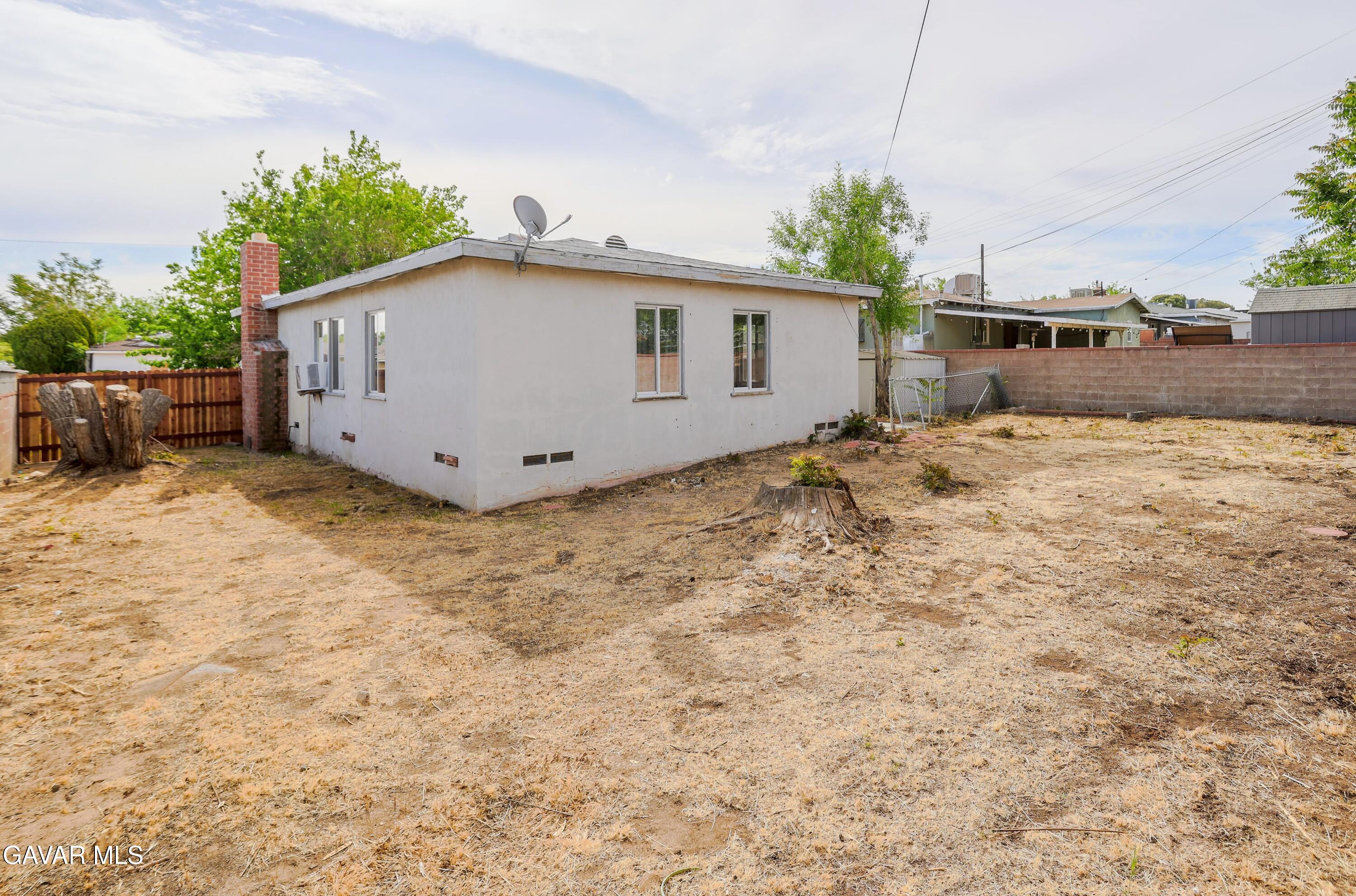 44265 Foxton Avenue Lancaster, CA 93535 - Photo 20 of 20 a white house that has a tree in front of it