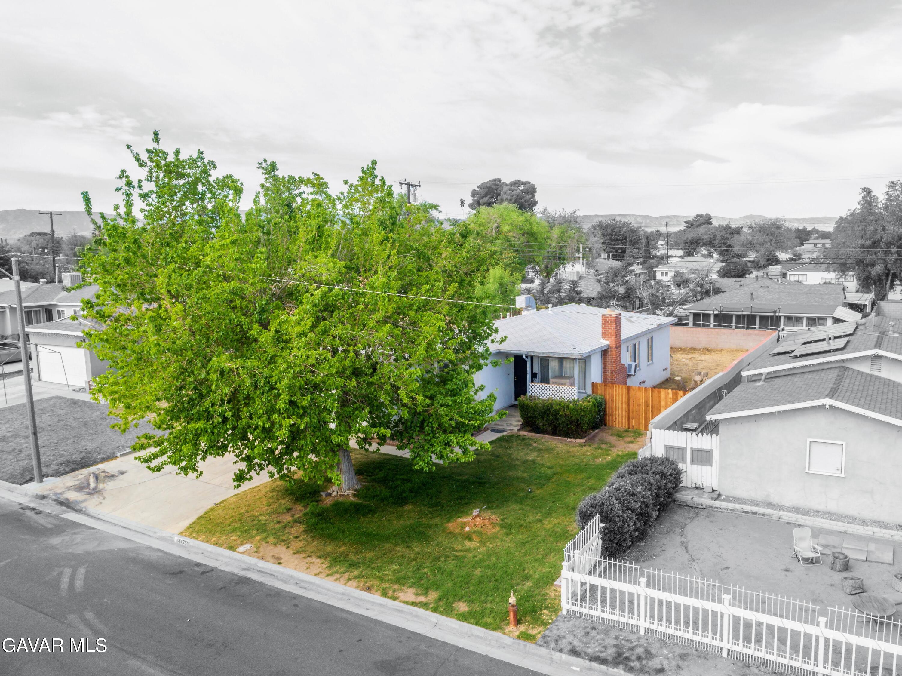 44265 Foxton Avenue Lancaster, CA 93535 - Photo 3 of 20 an aerial view of a house with a garden and trees