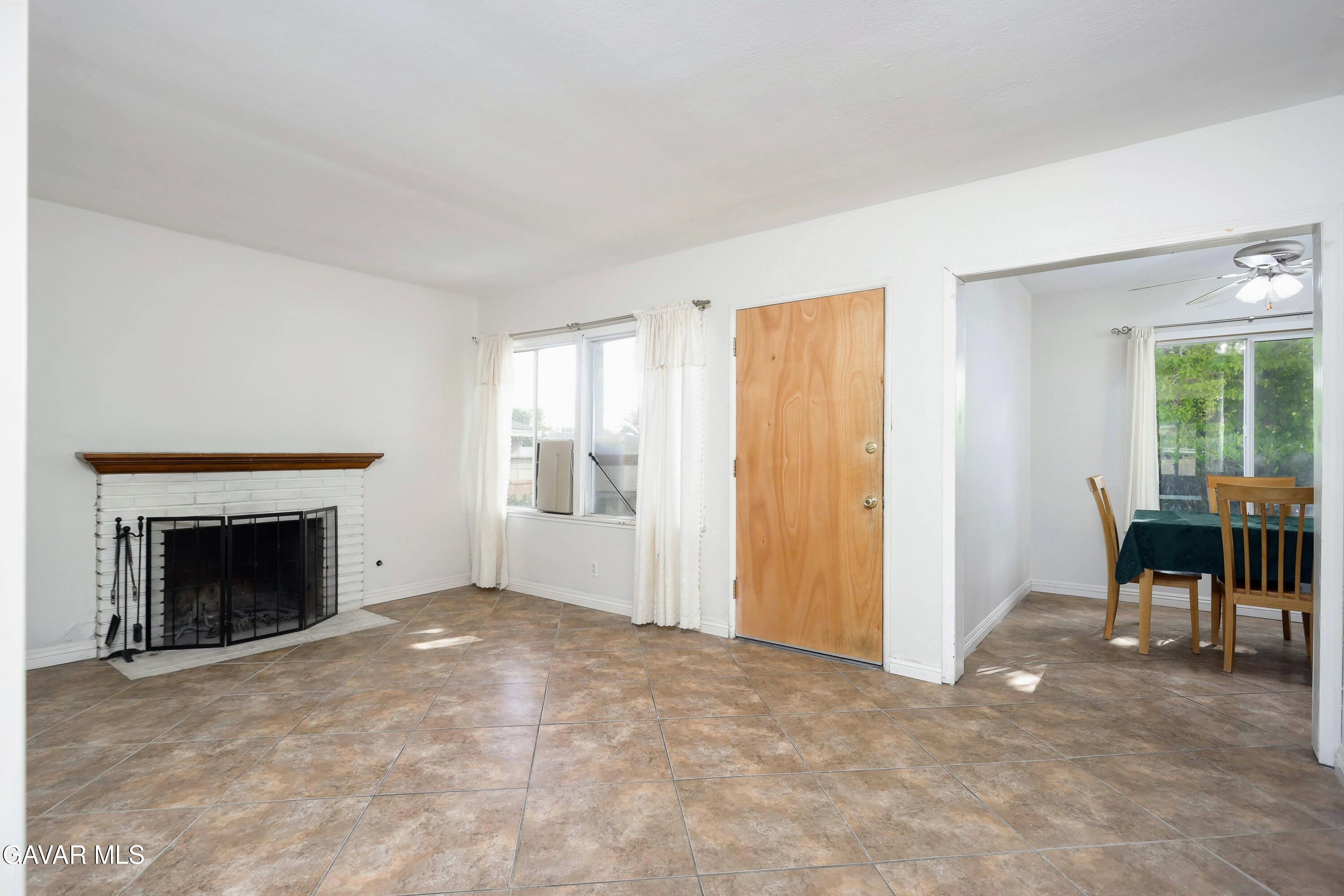 44265 Foxton Avenue Lancaster, CA 93535 - Photo 7 of 20 an empty room with furniture fireplace and windows