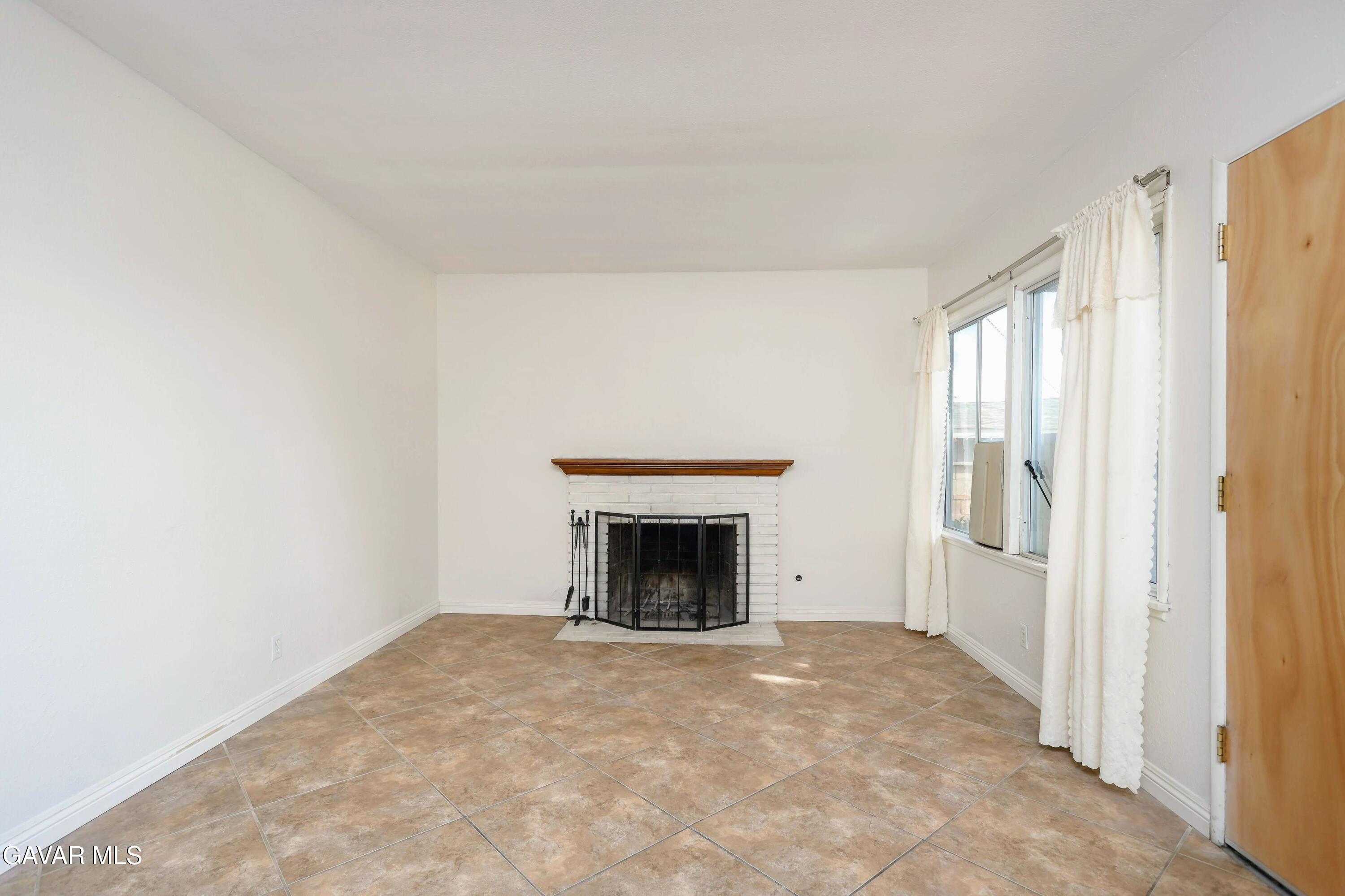 44265 Foxton Avenue Lancaster, CA 93535 - Photo 8 of 20 a view of empty room with a fireplace