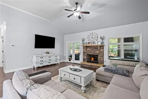 a living room with furniture a fireplace and a flat screen tv