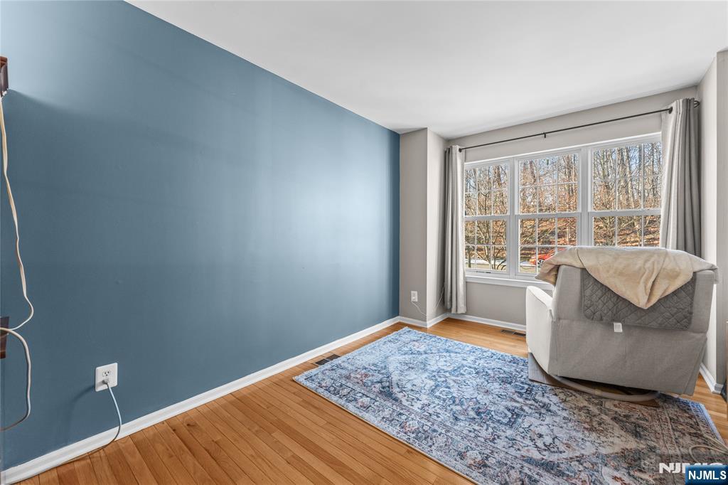 123 Butternut Drive Wayne, NJ 07470 - Photo 11 of 23 a bedroom with a bed and wooden floor