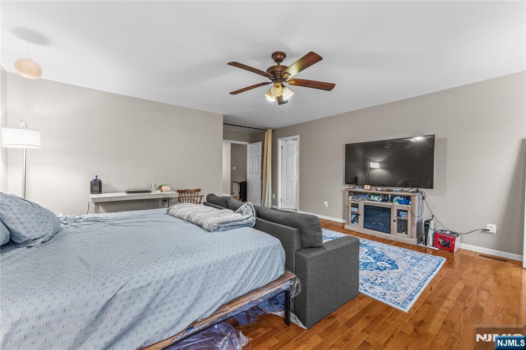 123 Butternut Drive Wayne, NJ 07470 - Photo 14 of 23 a bedroom with a bed and a flat screen tv