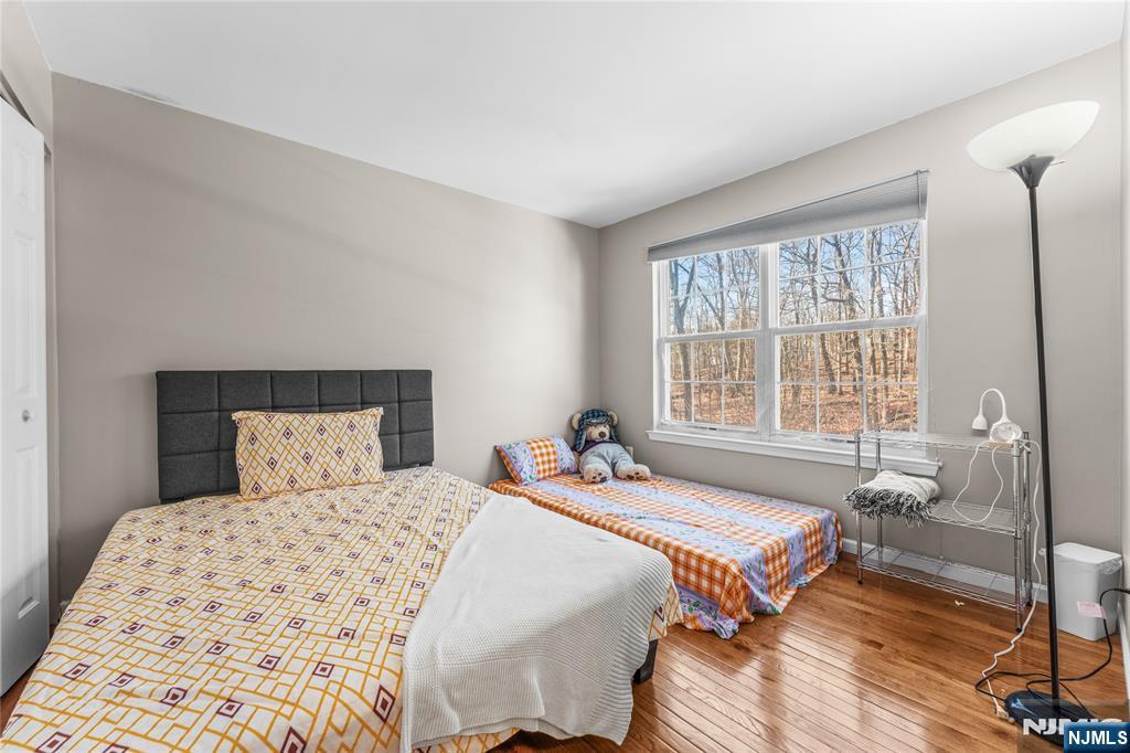 123 Butternut Drive Wayne, NJ 07470 - Photo 18 of 23 a bedroom with a bed and wooden floor
