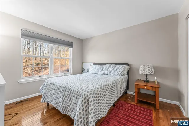 a bedroom with bed and window