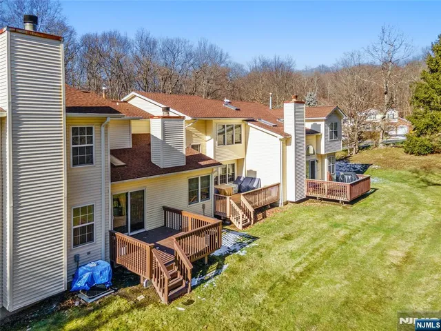 a view of a house with backyard porch and sitting area