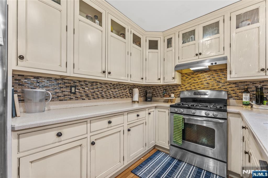 123 Butternut Drive Wayne, NJ 07470 - Photo 7 of 23 a kitchen with granite countertop white cabinets and white appliances