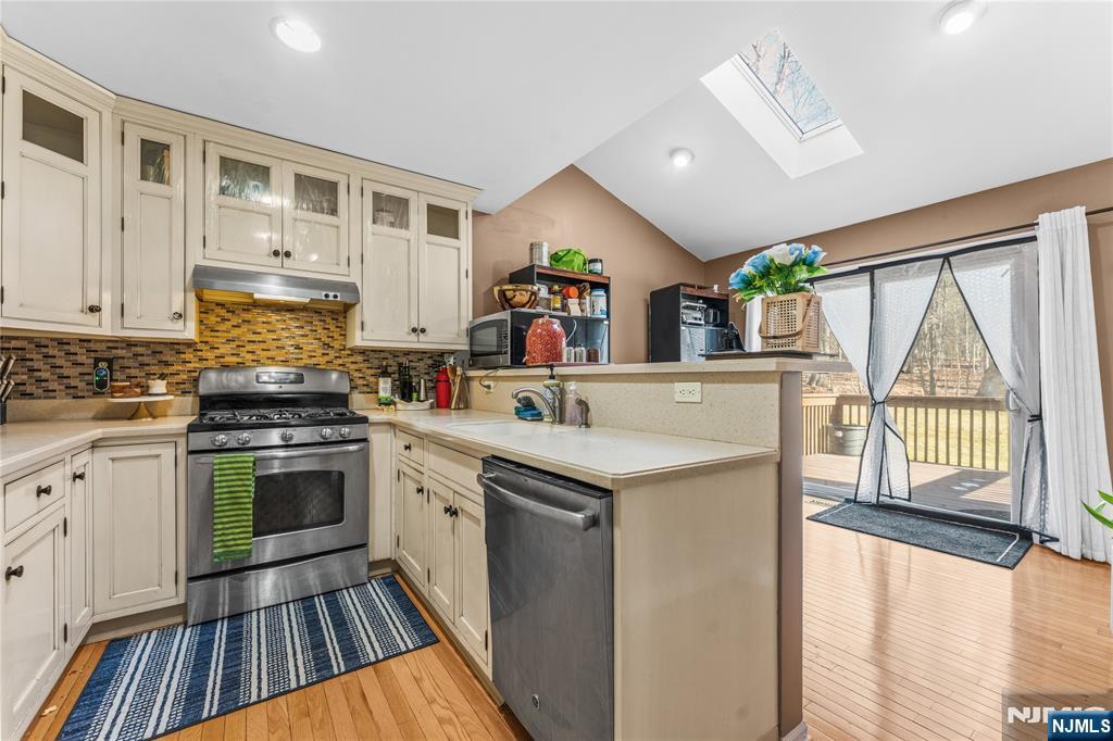 123 Butternut Drive Wayne, NJ 07470 - Photo 8 of 23 a kitchen with a sink stove and cabinets