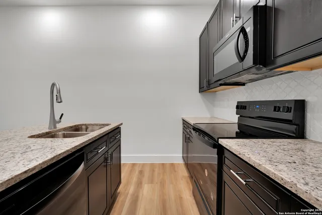 a kitchen that has a sink and a stove