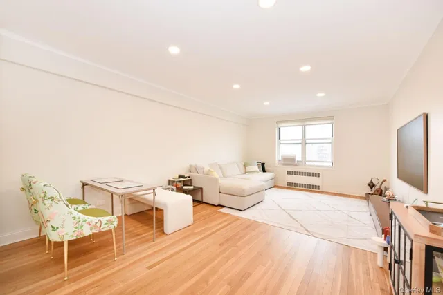 a bedroom with furniture and a flat screen tv