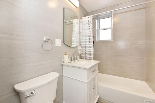 a bathroom with a sink a toilet and bathtub