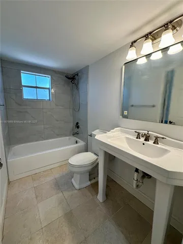 a bathroom with a sink a toilet and a bathtub