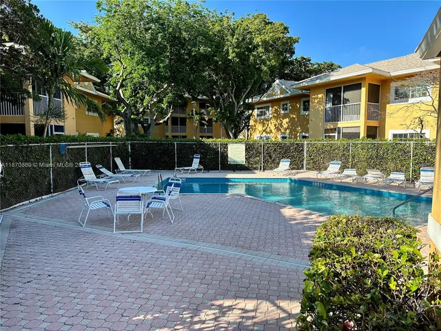a swimming pool with outdoor seating and yard