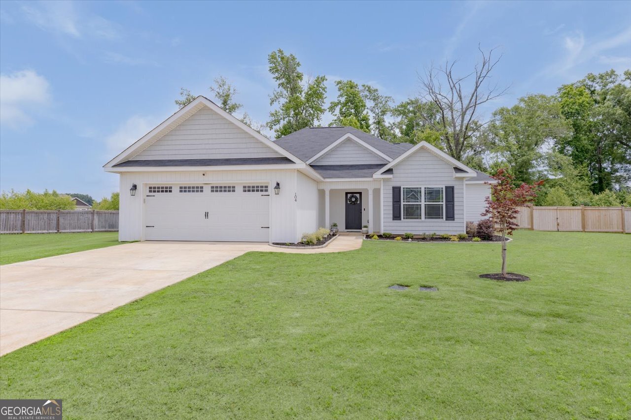 104 Meredith Layne Court Perry, GA 31069 - Photo 2 of 46 a front view of a house with a yard and garage