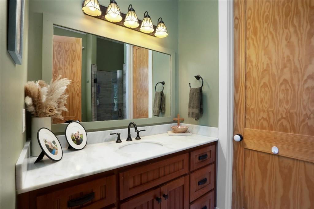 435 Walton Street Monroe, GA 30655 - Photo 24 of 55 a bathroom with a double vanity sink and a mirror