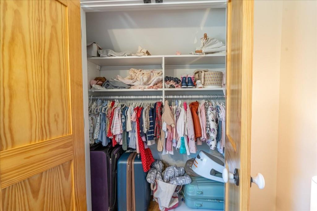 435 Walton Street Monroe, GA 30655 - Photo 39 of 55 a view of walk in closet with clothes and shoes