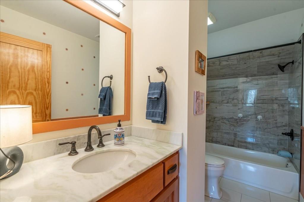 435 Walton Street Monroe, GA 30655 - Photo 41 of 55 a bathroom with a granite countertop sink toilet and shower