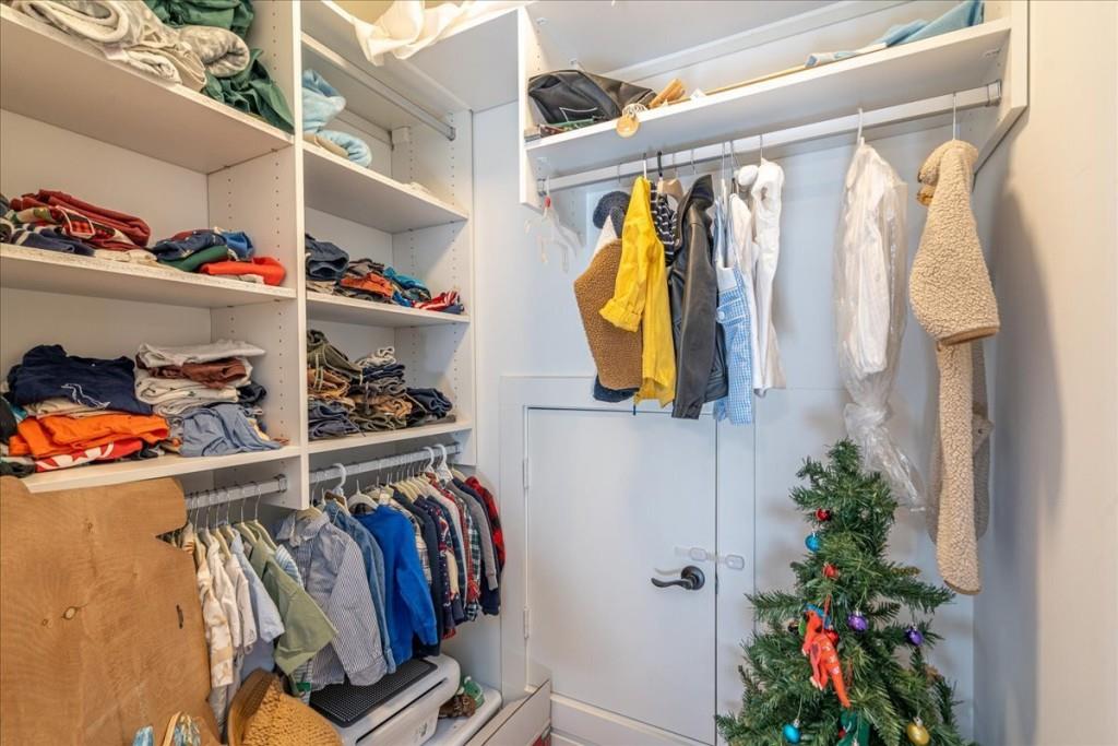 435 Walton Street Monroe, GA 30655 - Photo 44 of 55 a view of walk in closet with clothes and shoes