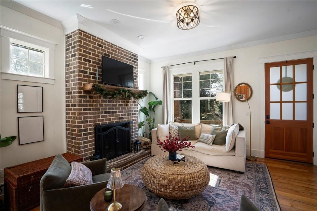 435 Walton Street Monroe, GA 30655 - Photo 8 of 55 a living room with furniture a fireplace and a flat screen tv