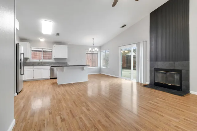 a view of a kitchen with wooden floor and a kitchen