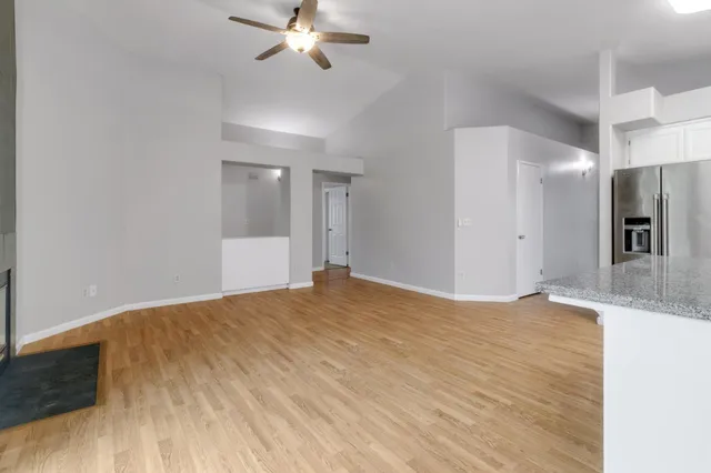 a view of an empty room with wooden floor