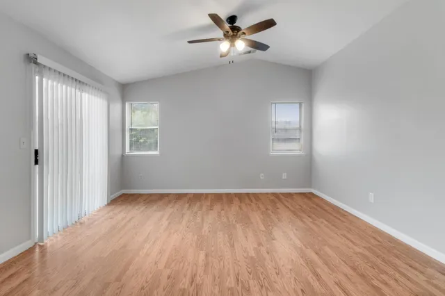 wooden floor in an empty room with a window