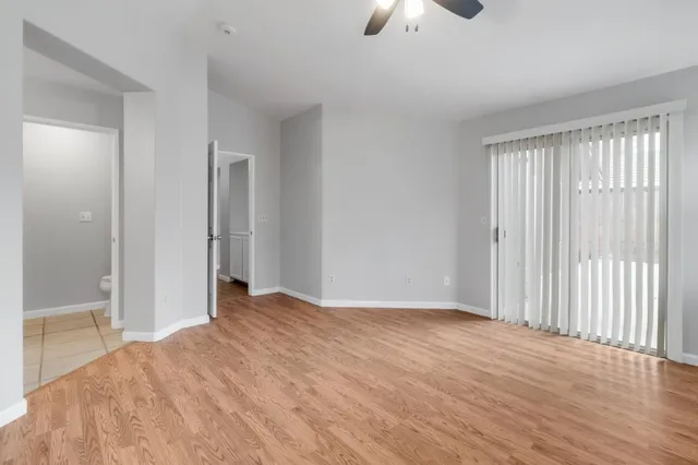 wooden floor chandelier and windows in a room