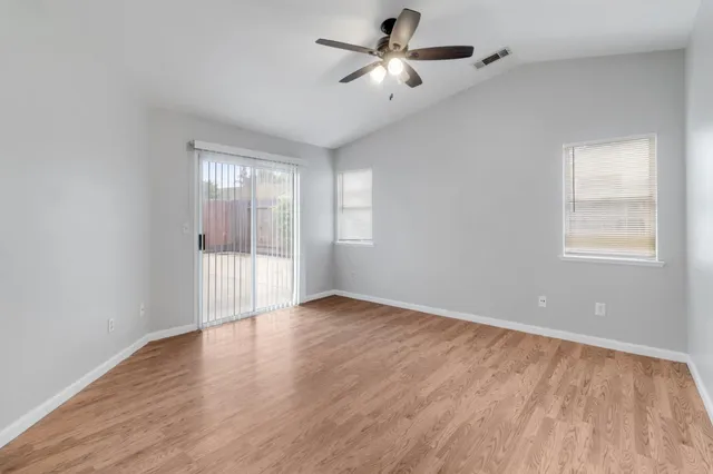 wooden floor in an empty room with a window