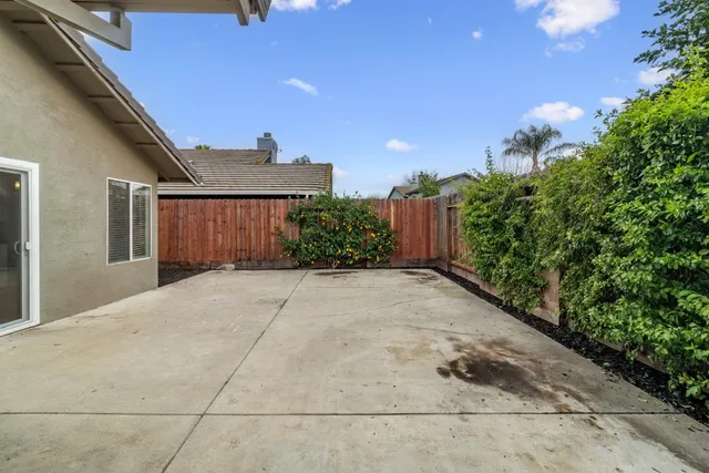 a view of a house with a yard and potted plants