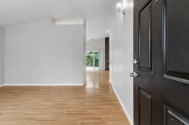a view of a hallway with wooden floor