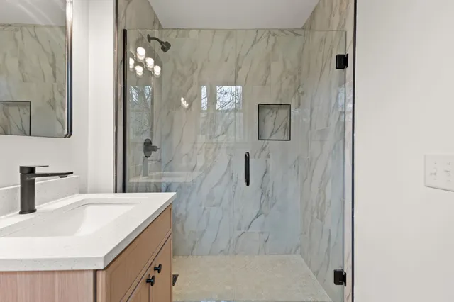 a bathroom with a sink and mirror