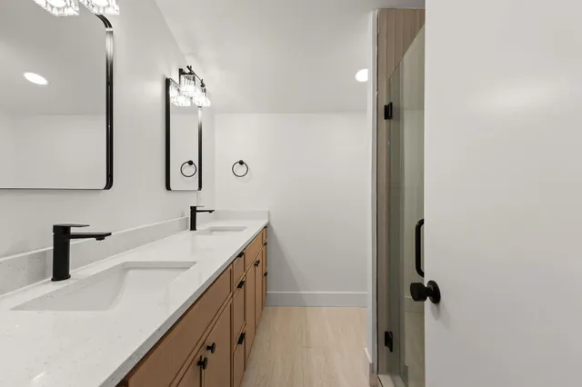 a bathroom with a double vanity sink and a mirror