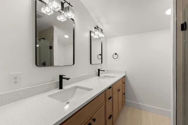 a bathroom with a double vanity sink and a mirror