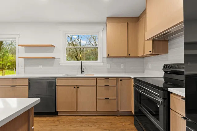a kitchen with a sink stove and cabinets