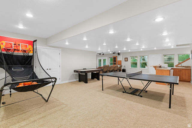 1133 Paris Canyon Road Paris, ID 83261 - Photo 41 of 74 Spacious recreation room featuring recessed lighting, light-toned carpeting, a built-in wet bar with wood cabinetry, and multiple windows