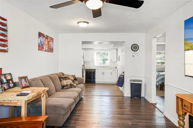 a living room with furniture wooden floor and a flat screen tv