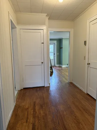 a view of hallway with wooden floor