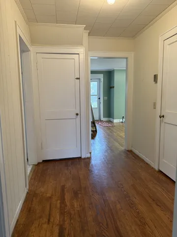 a view of hallway with wooden floor
