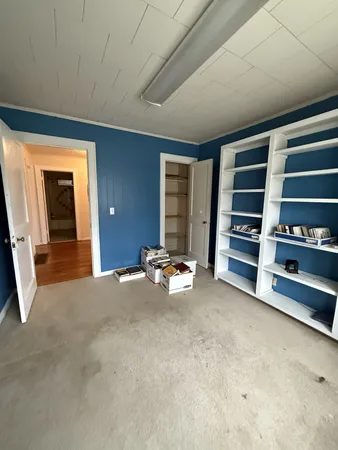 an empty room with furniture and closet