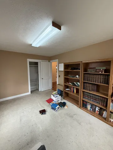 a view of room with furniture and closet