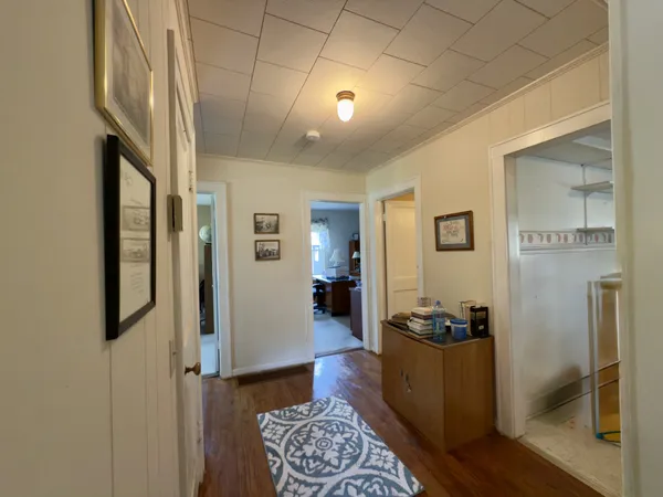 a view of a hallway with workspace and a window