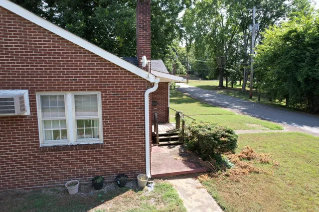 a view of a backyard with sitting area
