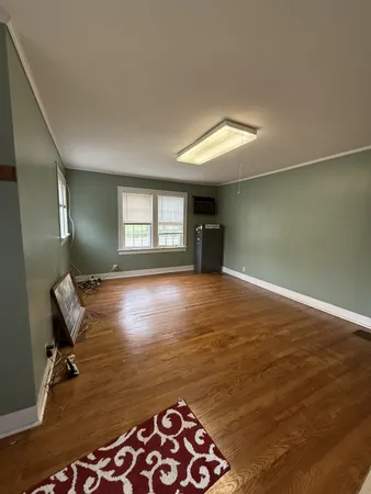 a view of room with window and hardwood floor