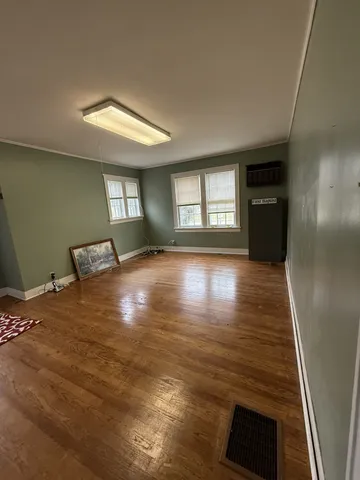 a view of empty room with window and fireplace