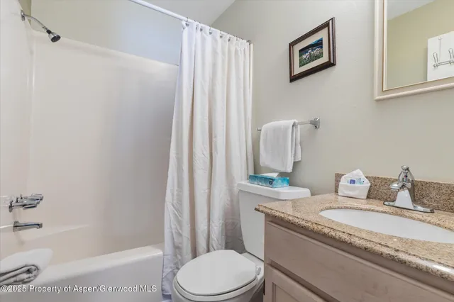 a bedroom with two beds and a flat screen tv