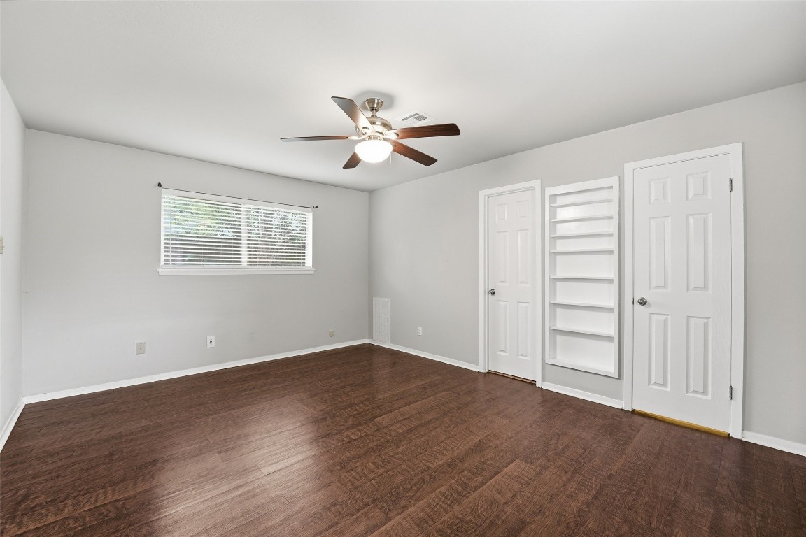5907 Peg Street Houston, TX 77092 - Photo 12 of 21 an empty room with wooden floor chandelier fan and windows