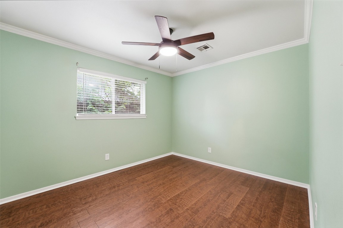 5907 Peg Street Houston, TX 77092 - Photo 16 of 21 an empty room with wooden floor and ceiling fan
