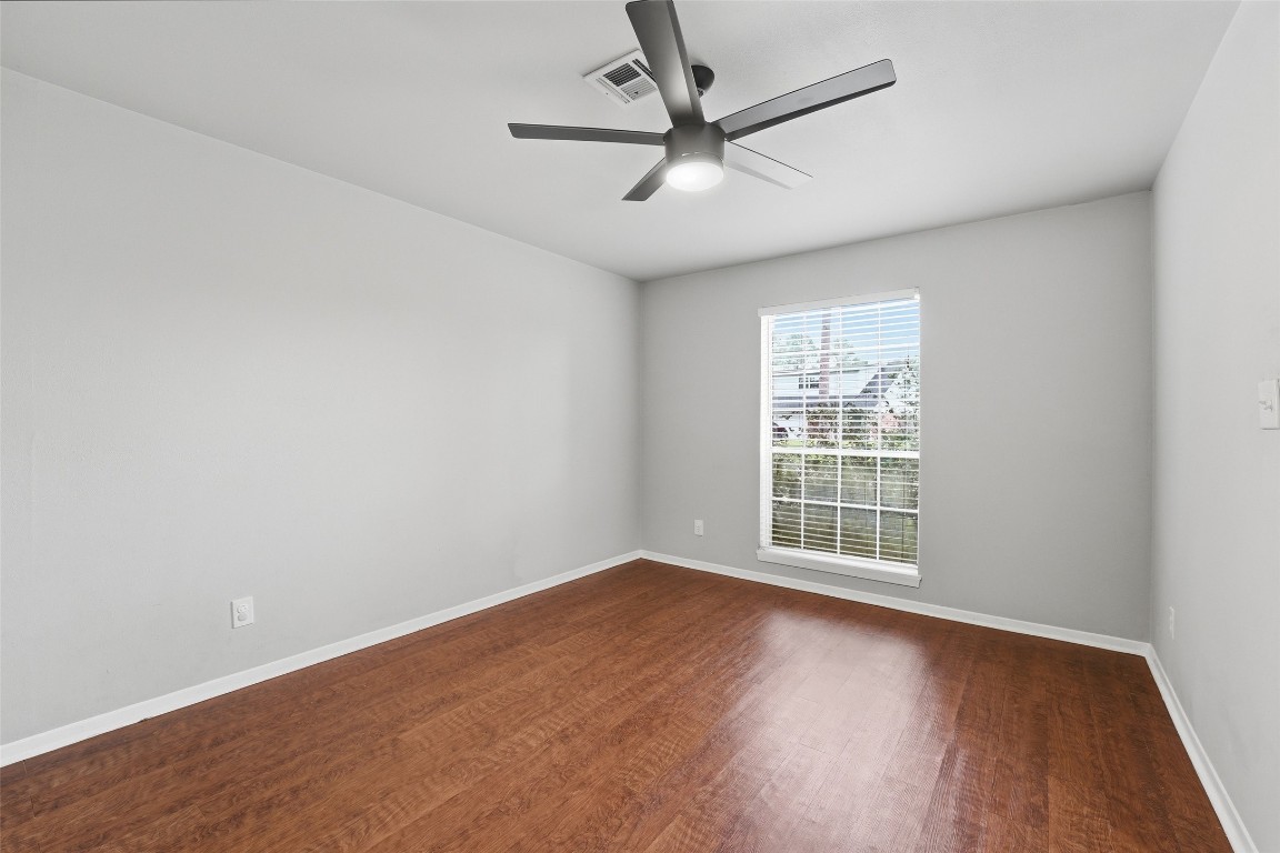 5907 Peg Street Houston, TX 77092 - Photo 3 of 21 an empty room with wooden floor and windows